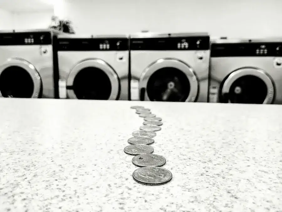 Quarters on a laundromat folding table